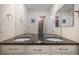 Double vanity bathroom with dark countertops at 20052 W 95Th Pl, Arvada, CO 80007