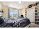 Spacious bedroom with large window, bookcase, and plush bedding at 20052 W 95Th Pl, Arvada, CO 80007