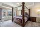Main bedroom with a large four poster bed and view at 20052 W 95Th Pl, Arvada, CO 80007