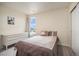 Well-lit bedroom featuring a dresser and a window with a view at 20052 W 95Th Pl, Arvada, CO 80007