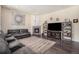 Living room with fireplace, TV, and built-in shelving at 20052 W 95Th Pl, Arvada, CO 80007
