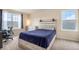 Bright bedroom with a queen-size bed and home office at 20052 W 95Th Pl, Arvada, CO 80007