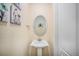Stylish powder room with pedestal sink and oval mirror at 20052 W 95Th Pl, Arvada, CO 80007
