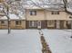 Front view of townhome covered in snow at 1229 S Uvalda St, Aurora, CO 80012