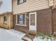 Front view of townhome's entrance in winter at 1229 S Uvalda St, Aurora, CO 80012