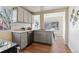 Updated kitchen with gray cabinets, stainless steel appliances, and a breakfast nook at 1971 Roslyn St, Denver, CO 80220