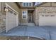 Front entry of home with stone, siding, and a two-car garage at 7427 Timberstone Trl, Castle Pines, CO 80108