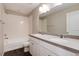 Bathroom with double vanity, tub, and neutral tile at 17574 Rose Heath Rd, Parker, CO 80134