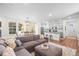 Open living room and kitchen with gray sectional sofa and island at 6165 Hanover St, Denver, CO 80238