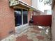 Small patio with brick walls, a grill, and a sliding glass door at 1165 Milky Way, Thornton, CO 80260