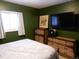 Bedroom with a double bed, dresser, and mounted TV at 1165 Milky Way, Thornton, CO 80260