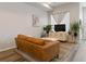 Living area with a brown leather couch and a modern coffee table at 5371 E 63Rd Pl, Commerce City, CO 80022