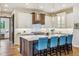 Bright kitchen features a large island with blue seating and a breakfast area at 1210 Wildcat Bend Ct, Castle Rock, CO 80108