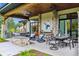 Covered patio with comfortable seating and an outdoor fireplace at 1210 Wildcat Bend Ct, Castle Rock, CO 80108