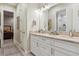 Basement bathroom with double vanity and access to bedroom at 1210 Wildcat Bend Ct, Castle Rock, CO 80108