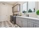 Laundry room with gray cabinetry, quartz countertops, and patterned tile floor at 1210 Wildcat Bend Ct, Castle Rock, CO 80108