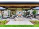 Covered patio with comfortable seating and an outdoor fireplace at 1210 Wildcat Bend Ct, Castle Rock, CO 80108