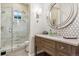Spa-like bathroom with a walk-in shower, modern vanity, and elegant mirror at 1210 Wildcat Bend Ct, Castle Rock, CO 80108