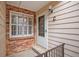 Front entrance with brick and siding, and a small patio at 13824 E Lehigh Ave # C, Aurora, CO 80014