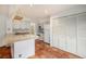 Open concept kitchen with white cabinets, tile floors, and a breakfast bar at 13824 E Lehigh Ave # C, Aurora, CO 80014