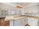 Spacious kitchen with white cabinets, tile floors, and a breakfast bar at 13824 E Lehigh Ave # C, Aurora, CO 80014