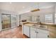 Kitchen with white cabinets, tile floors, and a view of the backyard at 13824 E Lehigh Ave # C, Aurora, CO 80014