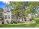 Rear exterior view showing a charming home with a landscaped yard at 13824 E Lehigh Ave # C, Aurora, CO 80014