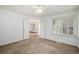 Well-lit bedroom with carpet and access to another room at 13824 E Lehigh Ave # C, Aurora, CO 80014