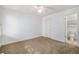 Spacious bedroom with carpet, a ceiling fan, and access to a bathroom at 13824 E Lehigh Ave # C, Aurora, CO 80014