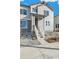 Two-story townhome with gray siding, white railing, and gravel landscaping at 2186 Farmlore Dr, Brighton, CO 80601