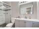 Updated bathroom with gray vanity, walk-in shower, and large mirror at 3256 S Elm St, Denver, CO 80222