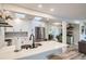 Updated kitchen featuring white shaker cabinets, quartz countertops, and stainless steel appliances at 3256 S Elm St, Denver, CO 80222