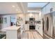 Modern white kitchen with stainless steel appliances and quartz countertops at 3256 S Elm St, Denver, CO 80222