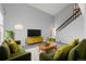 Bright living room with mid-century modern furniture and a high ceiling at 8787 Yukon St, Arvada, CO 80005