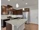 Modern kitchen with island and stainless steel appliances at 19733 W 93Rd Ln # D, Arvada, CO 80007