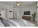 Spacious bedroom with TV stand, ceiling fan, and ensuite bathroom access at 19733 W 93Rd Ln # D, Arvada, CO 80007