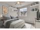 Bright bedroom with floating shelves, window, and ceiling fan at 19733 W 93Rd Ln # D, Arvada, CO 80007