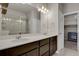 Modern bathroom with double vanity, large mirror, and walk-in closet at 19733 W 93Rd Ln # D, Arvada, CO 80007