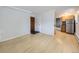 Light-filled living room with wood-look floors and access to kitchen at 1 S Pennsylvania St # 102, Denver, CO 80209