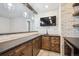 Basement bar with wood cabinets, granite counters, and a wine cooler at 7912 Galileo Way, Littleton, CO 80125