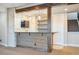 Basement wet bar with tiled backsplash and rustic wooden countertop at 7912 Galileo Way, Littleton, CO 80125