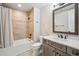 Basement bathroom with a tub, shower, and vanity at 7912 Galileo Way, Littleton, CO 80125