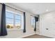 Bright basement bedroom with large windows and built-in shelving at 7912 Galileo Way, Littleton, CO 80125