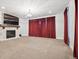 Finished basement living room with fireplace and carpeting at 7912 Galileo Way, Littleton, CO 80125