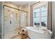 Spa-like bathroom with walk-in shower and a free-standing bathtub at 7912 Galileo Way, Littleton, CO 80125
