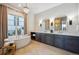 Elegant bathroom boasting double vanity, soaking tub, and separate shower at 7912 Galileo Way, Littleton, CO 80125