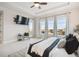 Bright bedroom with large windows offering scenic views and a comfortable sitting area at 7912 Galileo Way, Littleton, CO 80125