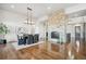 Elegant dining room with hardwood floors, a statement light fixture, and a brick fireplace at 7912 Galileo Way, Littleton, CO 80125
