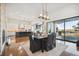 Open concept dining room with kitchen views, hardwood floors, and access to a deck at 7912 Galileo Way, Littleton, CO 80125