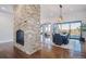 Spacious dining area with hardwood floors, a large brick fireplace, and access to a deck at 7912 Galileo Way, Littleton, CO 80125